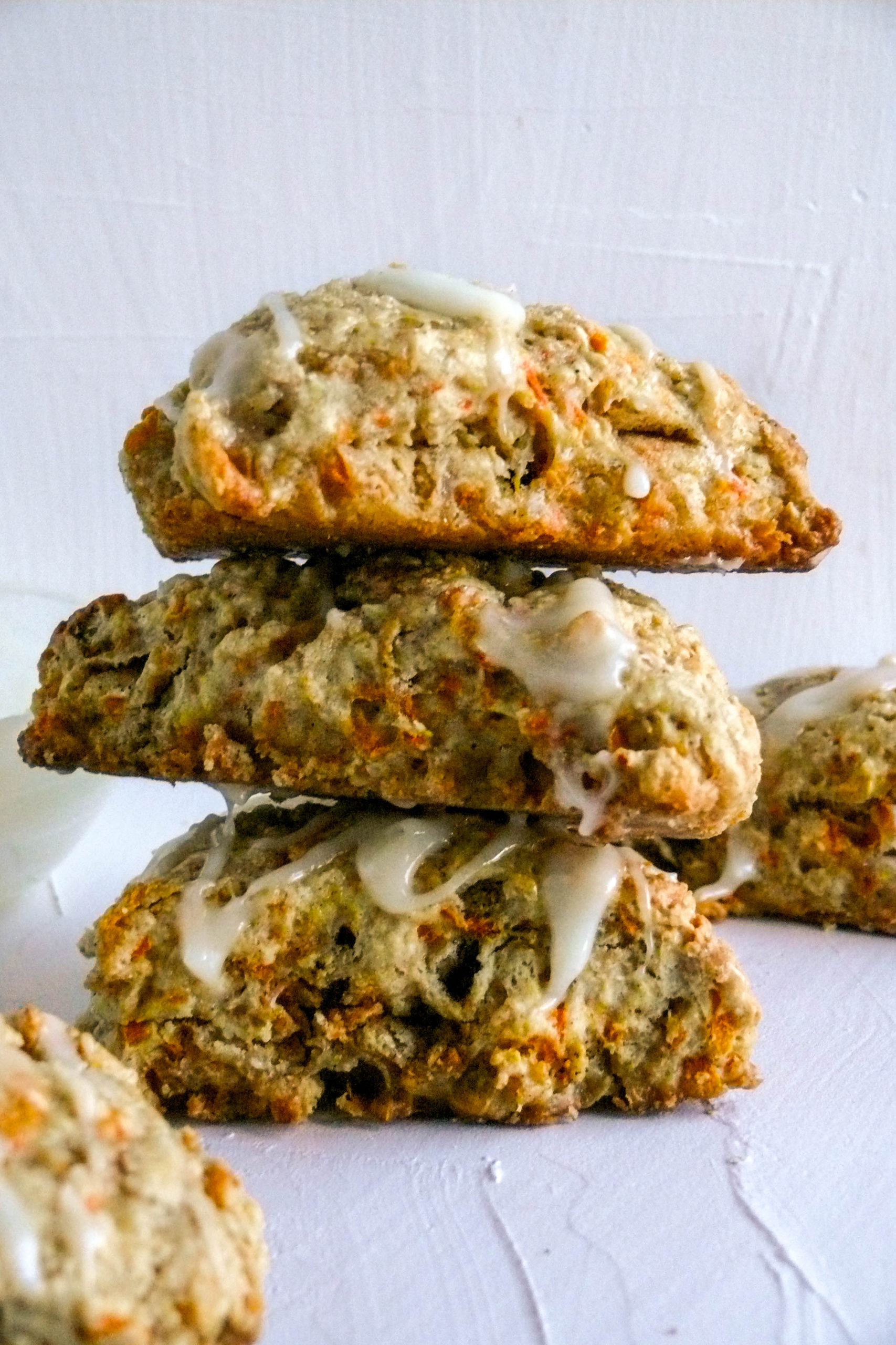 Carrot Scones stacked with bowl of cream cheese in the background