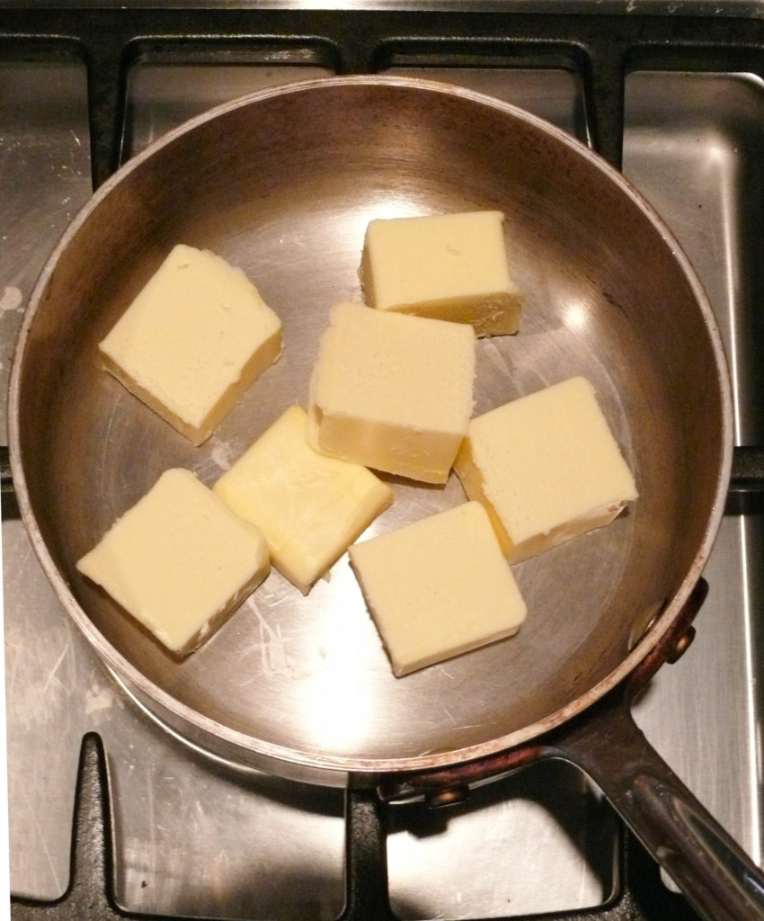 the butter sliced up in a saucepan