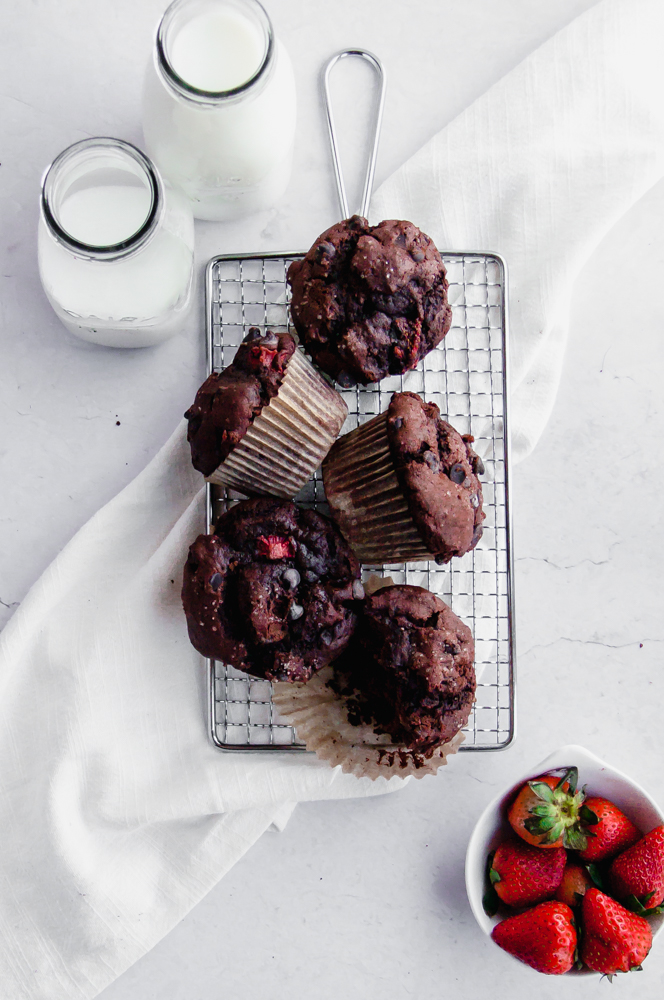 Five small batch chocolate strawberry muffins on a tray together