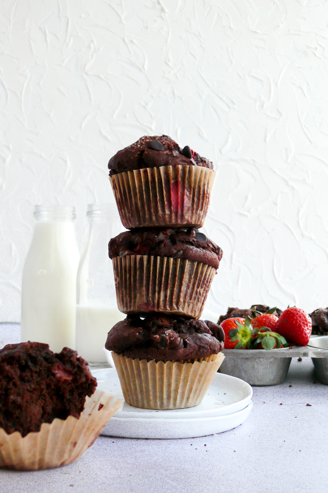 small batch chocolate strawberry muffins stacked with milk jugs