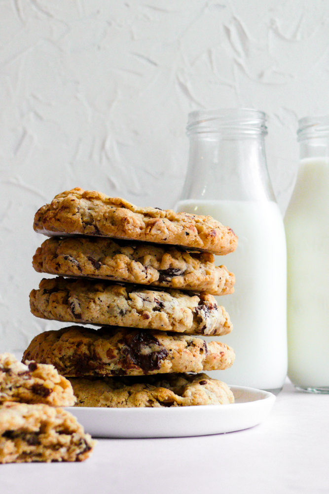 Stacked Brown Butter Oatmeal Cookies with a glass of milk