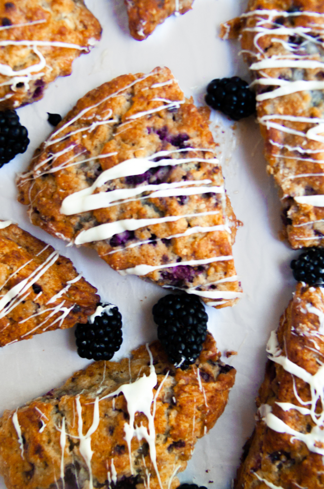 5 scones in an overhead shot with berries scattered around them