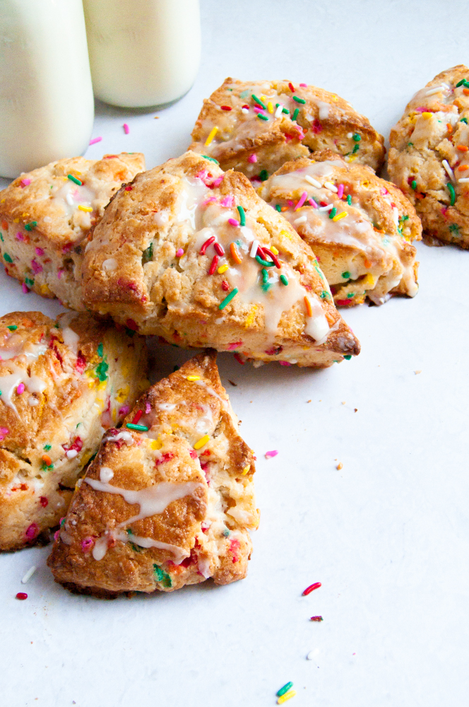 Funfetti scones stacked in a c shape with sprinkles behind them
