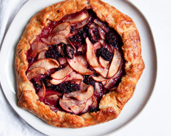 Wide shot of the blackberry pie on a plate surrounded with a napkin