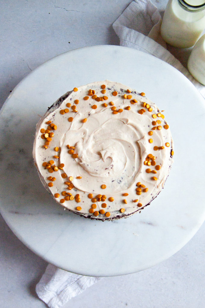 An overhead view of the chocolate cake with caramel frosting and sprinkles on top