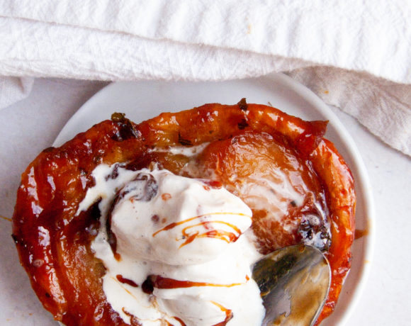 overhead apple tartlet topped with ice cream and caramel