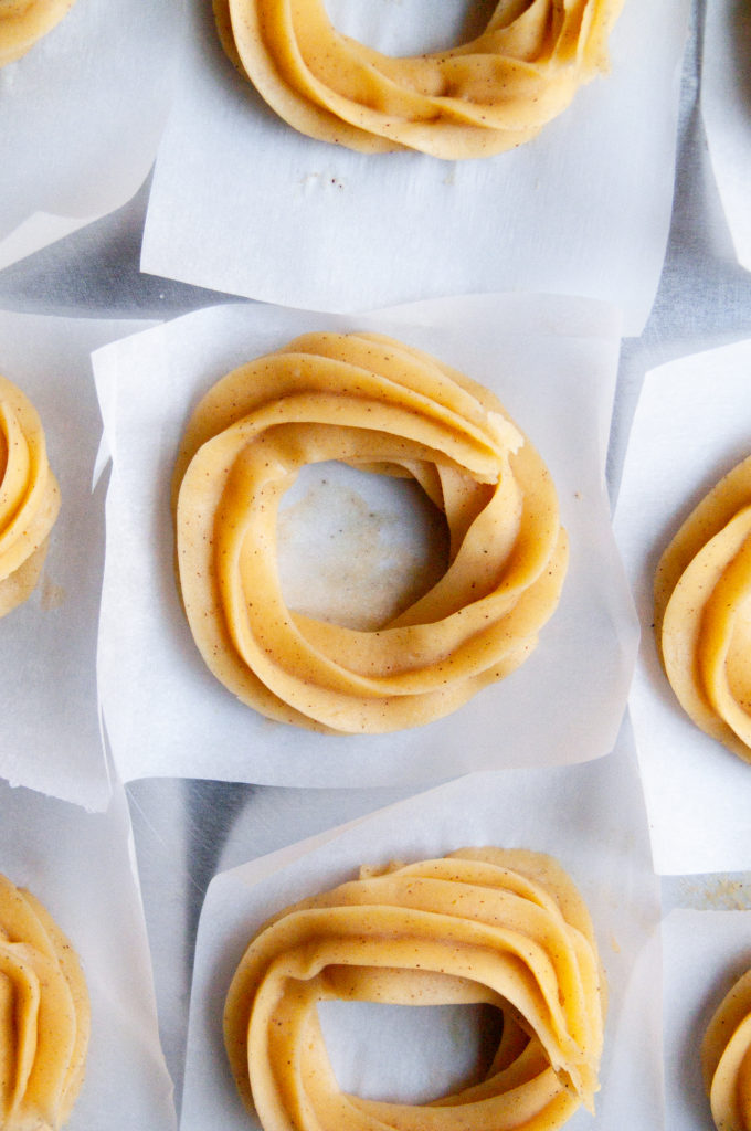 Unfried piped crullers in a macro overhead shot