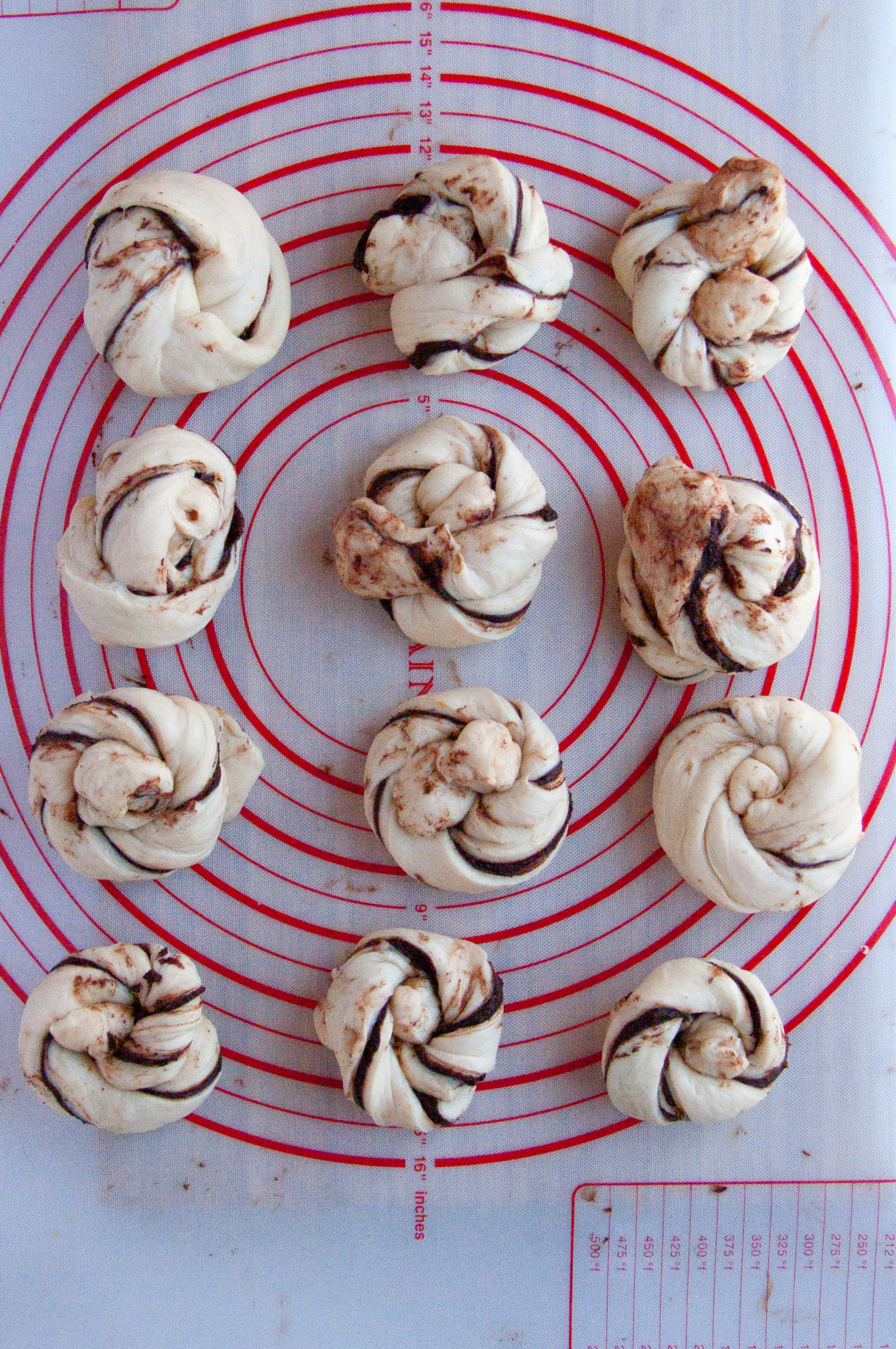 assembled chocolate buns on a baking mat